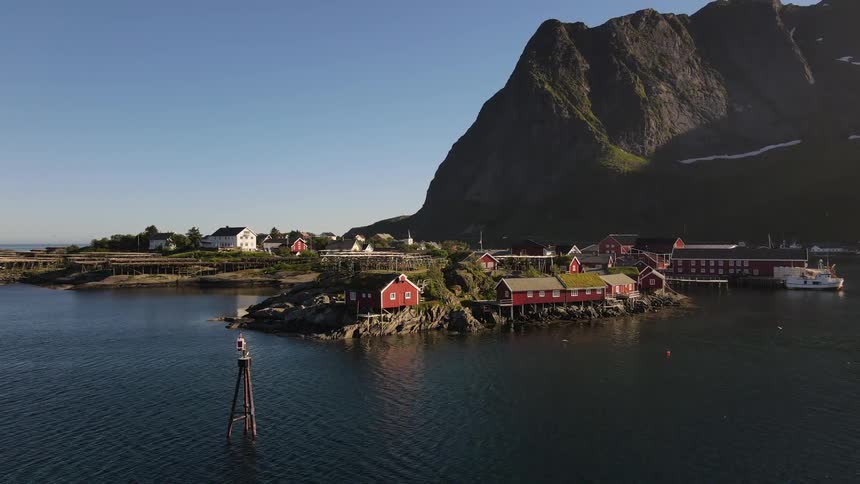Coastal town next to a mountain at morning