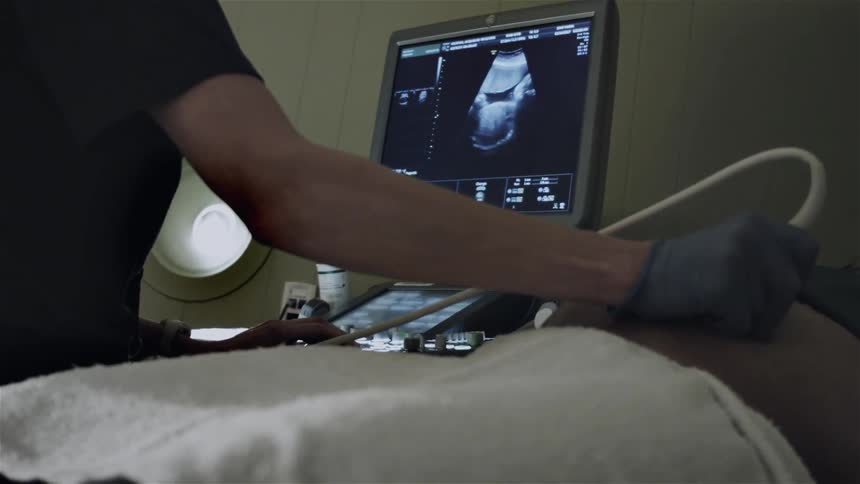 A person is being examined by a medical technician