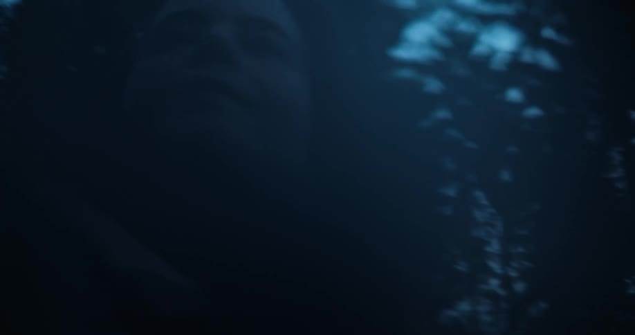 Close up of a woman looking up in the forest at night