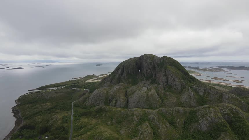 Aerial of an island with a mountain in the middle of the ocean