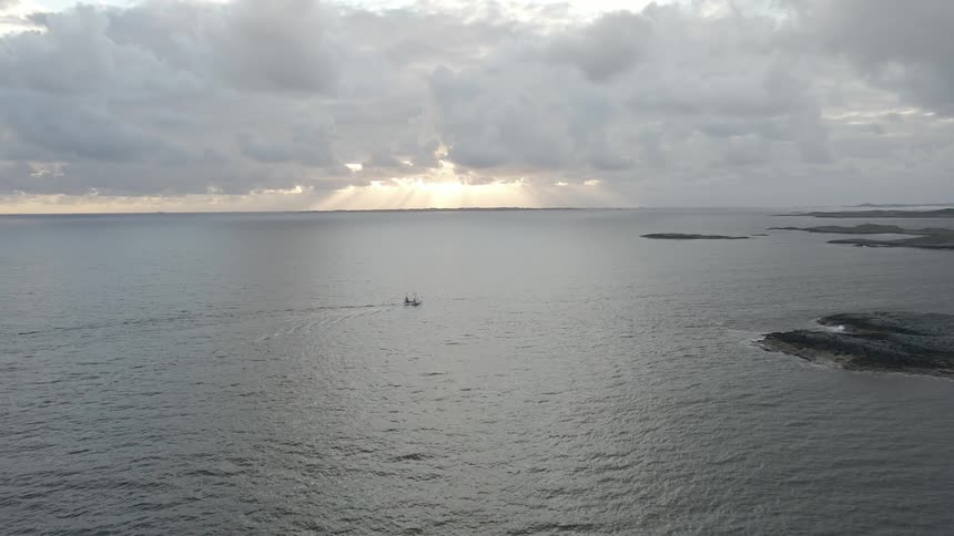 Aerial of a boat sailing near the beach shore
