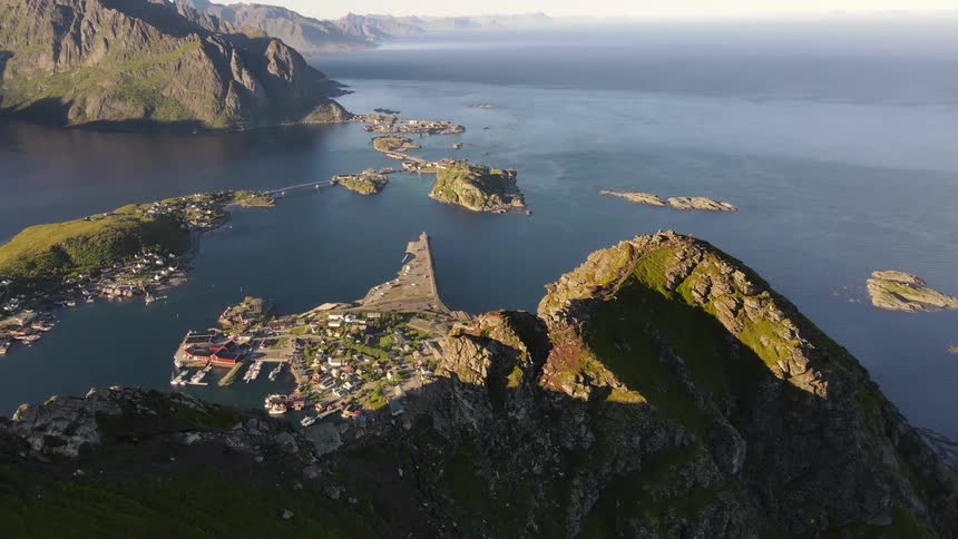 Aerial panorama of a peak in the mountains overlooking the sea with islands