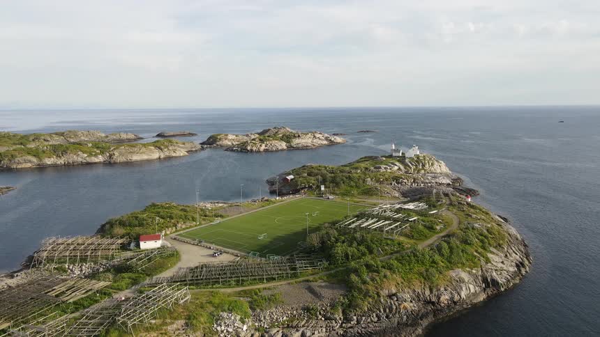 Aerial view of a soccer field on an island next to the ocean