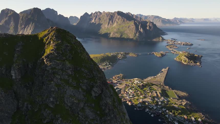 Aerial panorama of mountains and lakes with a city ahead on an island