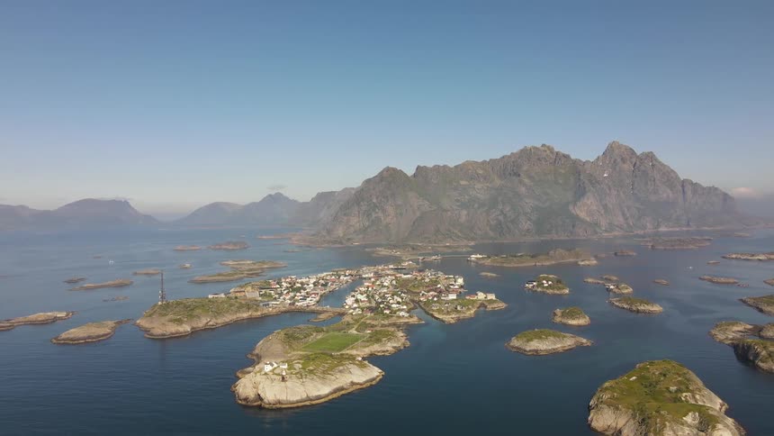 Town occupies multiple islands off mountainous coast on a foggy day
