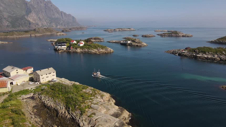 Boat traveling along the sea among small islands