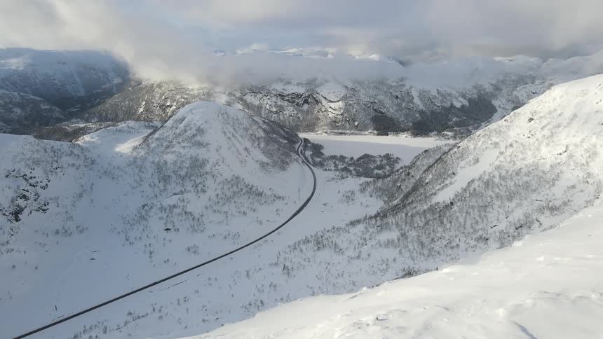 Aerial view of a snow capped valley and mountains