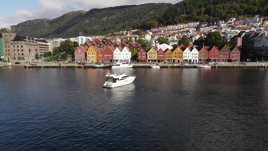 Aerial view of a small waterfront village and some yachts and boats at the peer