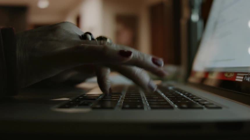 A person is typing on a laptop