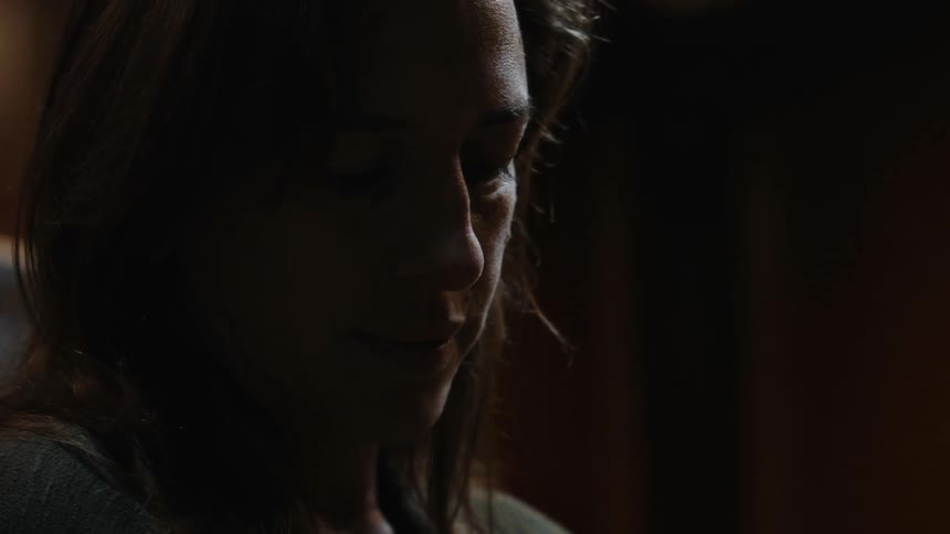 Close up of a woman's face in a dark room