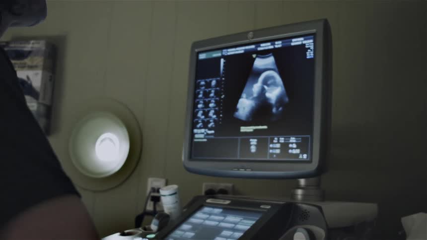 A person is looking at a baby monitor