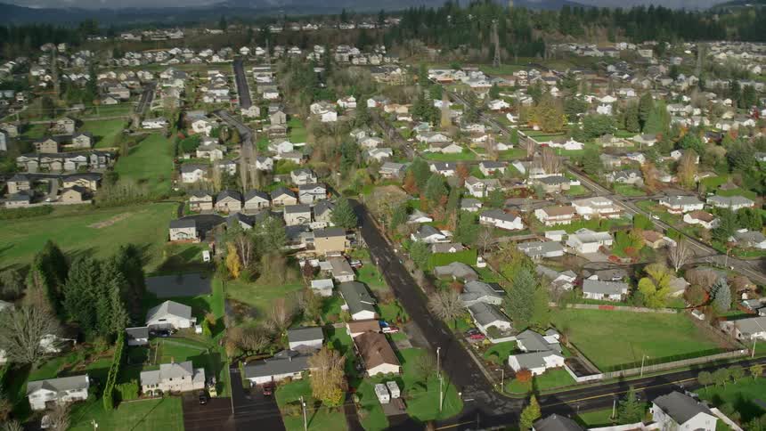 Aerial panorama of a residential neighborhood with mountains in the horizon