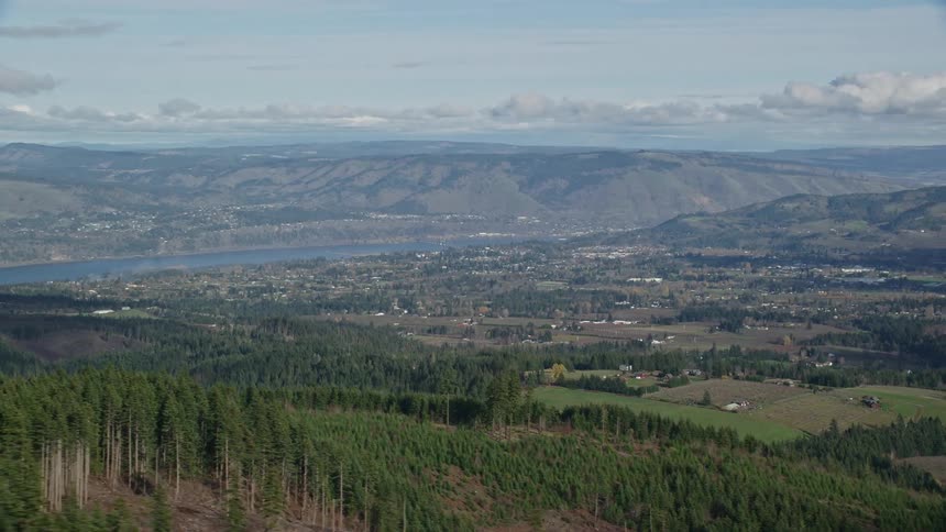 Aerial view of a small town next to a river on the mountains