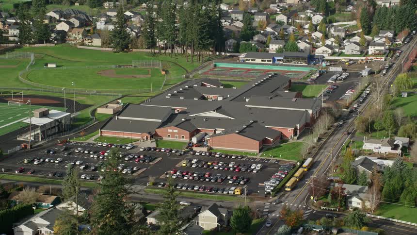 Aerial of a suburban neighborhood with sports courts during the day