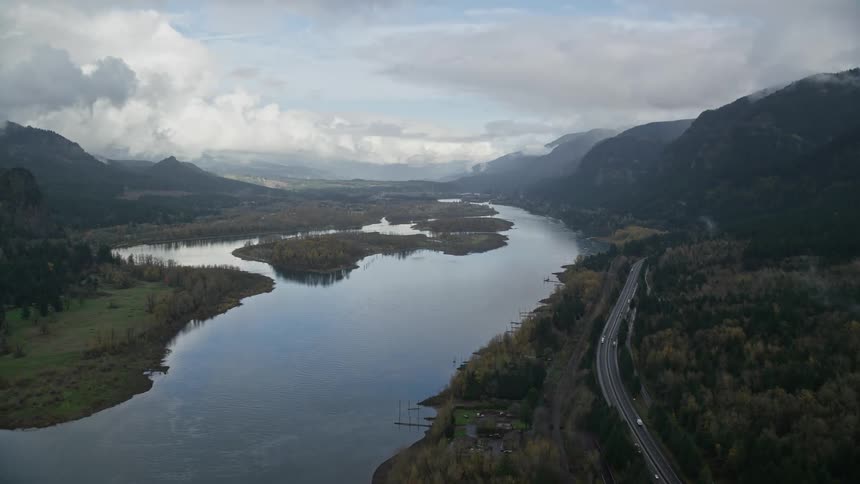 Aerial view of a central lake amidst mountains and a road
