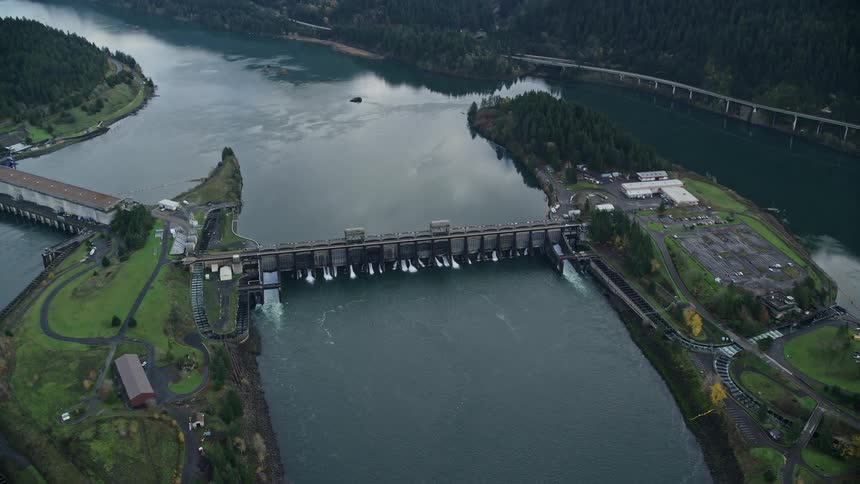 A dam on a lake near mountains