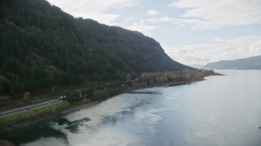 Aerial panorama of a central road in the middle of a lake and mountains