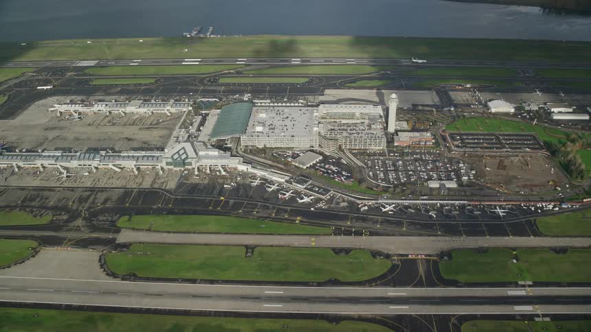 A number of airplanes are lined up at a medium sized airport