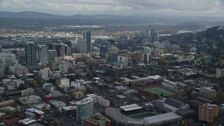 Skyline of an urban city with an american football field
