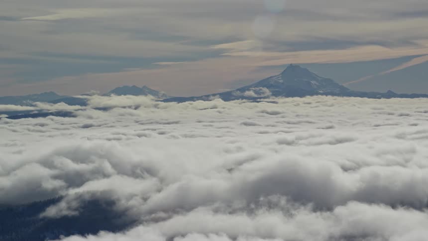 Aerial panorama of dense clouds and a mountain range on the horizon in the morning