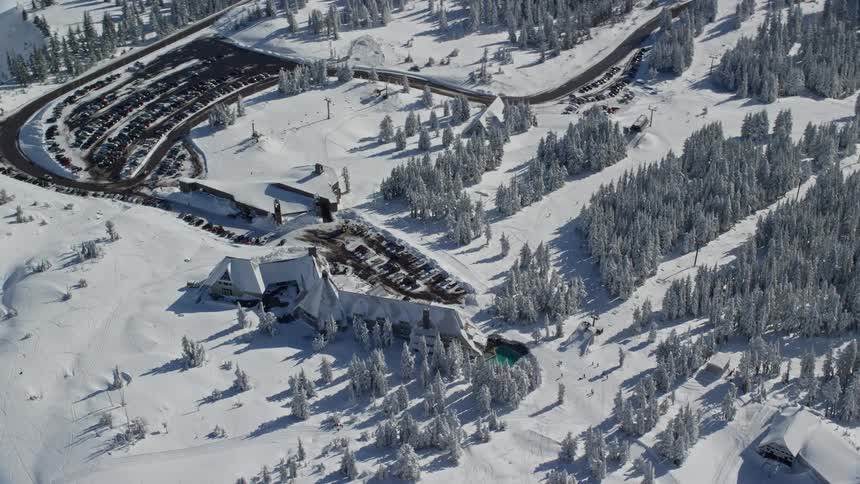 Aerial panorama of houses amidst snowcovered mountains