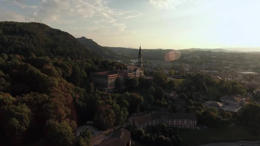 Aerial view of a church on a tree covered mountain