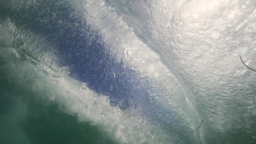 A person surfing a wave during a hot day