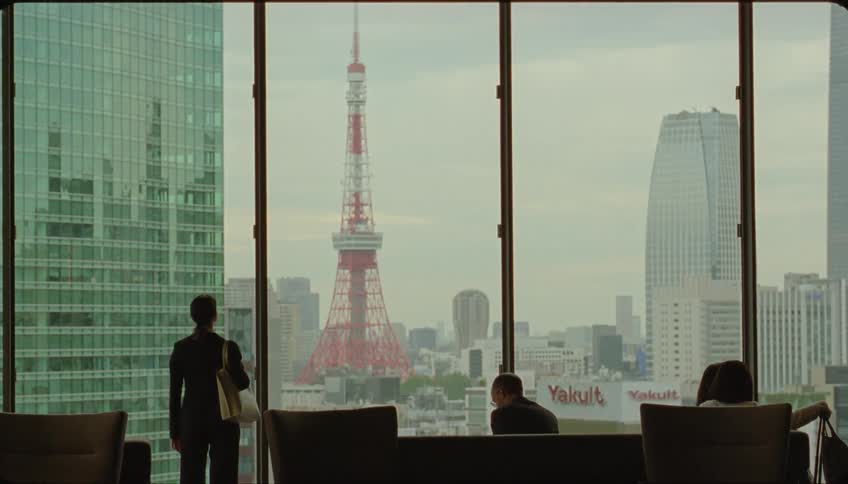 People are watching the city skyline from the window