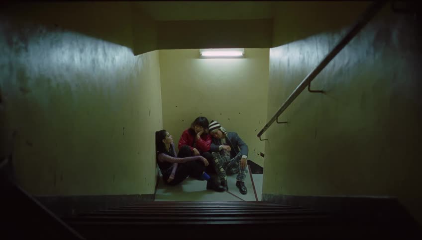 Group of friends sitting on the staircase of a building