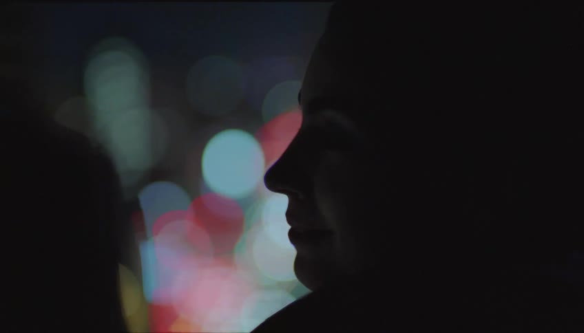 Silhouette of friends talking in the city at night
