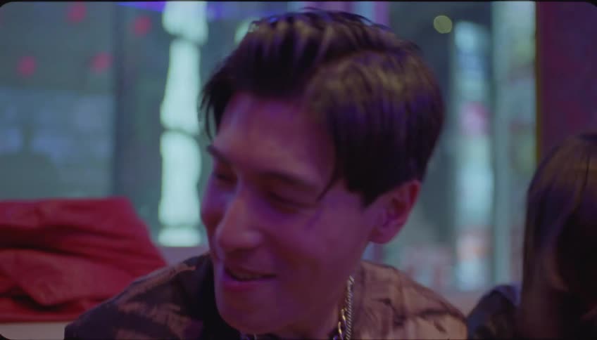 Friends sitting at a night club dance to the music