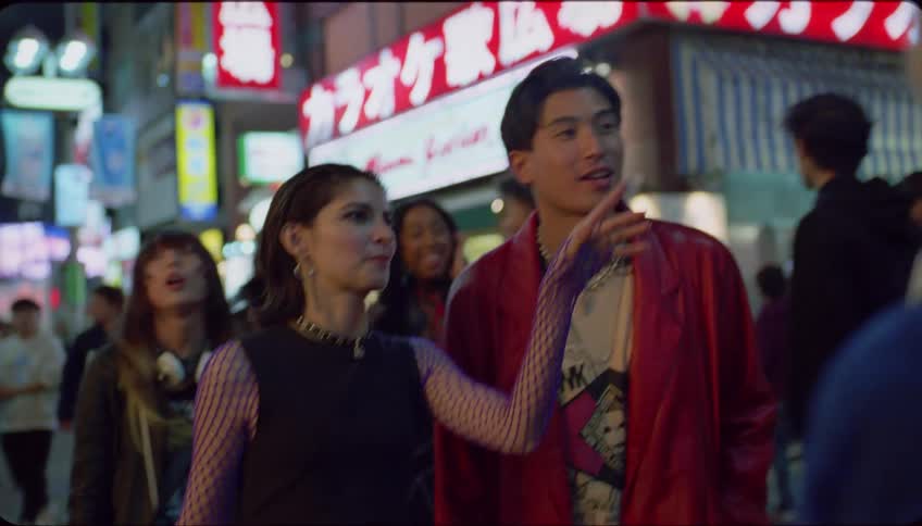 Group of friends walking on the city streets at night