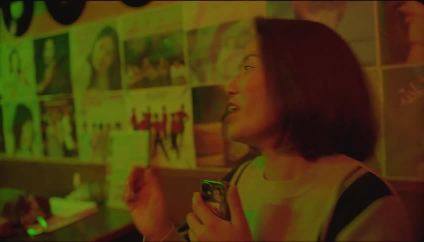 A woman in a bar singing a song
