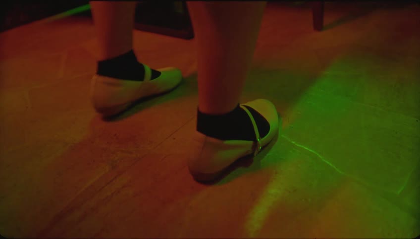 Close up of the feet of a young woman dancing at a party
