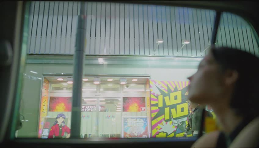 Woman on the back of a taxi driving on the city streets