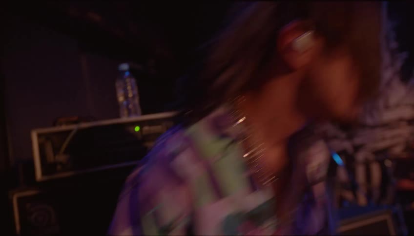 A man is playing the guitar on stage