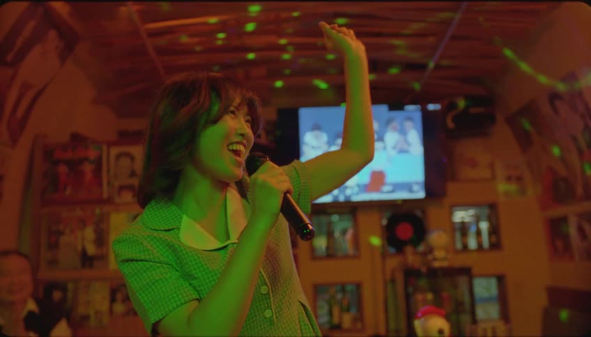 Friends greeting a woman singing karaoke in a pub