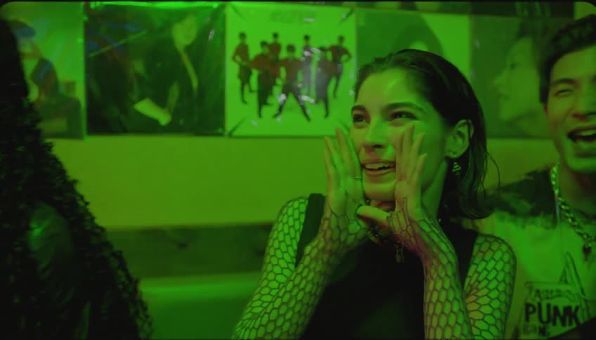A girl sings karaoke while her friends watch