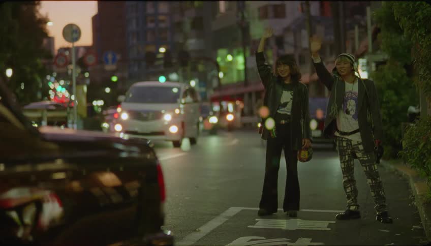 Woman saying goodbye to her friends and getting into a taxi