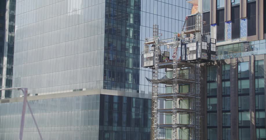 Scaffolding on the exterior of mirrored skyscrapers