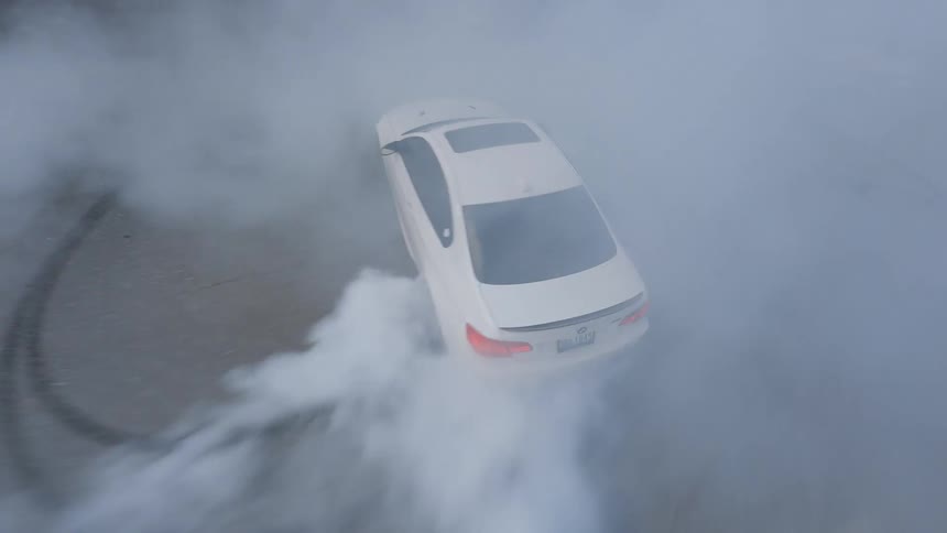 Car drifting on a parking lot in the mountains
