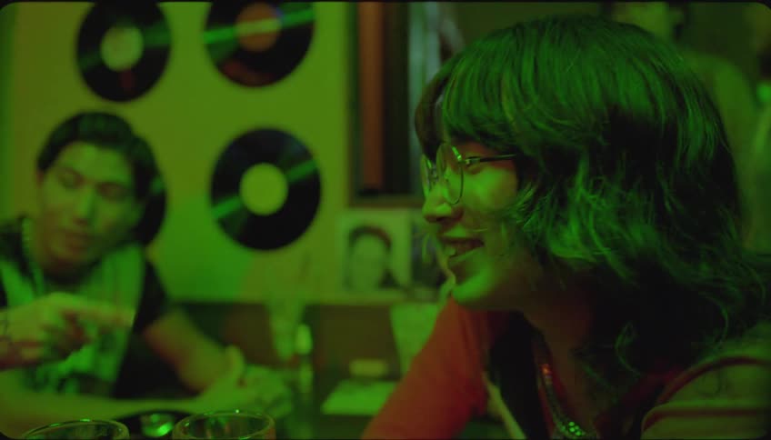Friends sitting at a table conversing in a nightclub