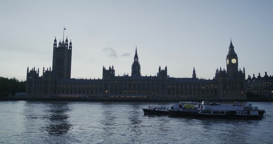 Sky reflecting the water in front of big ben historical landmark building with clock tower at dusk