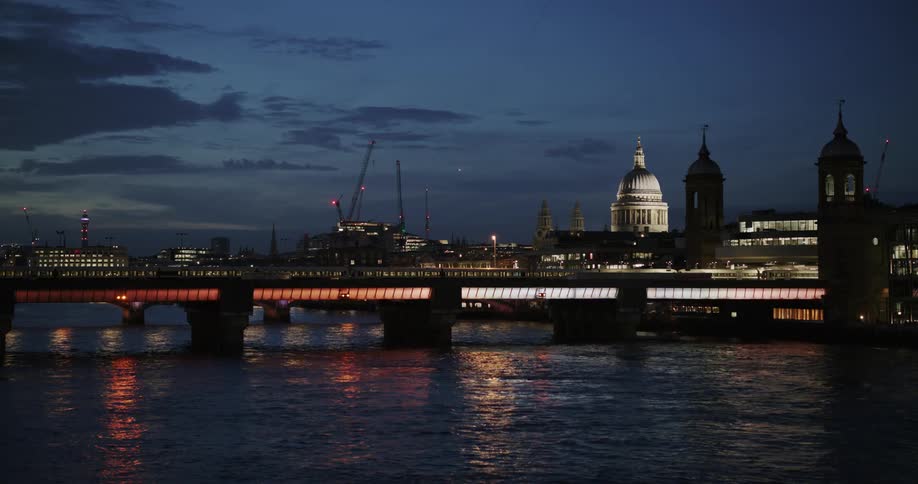 A train passes over the bridge by the city