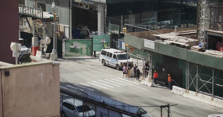 A busy city street with a blocked exit due to construction