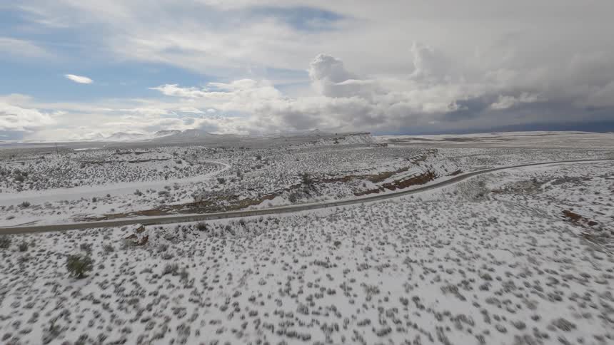 An aerial view of a snowcovered road in the desert