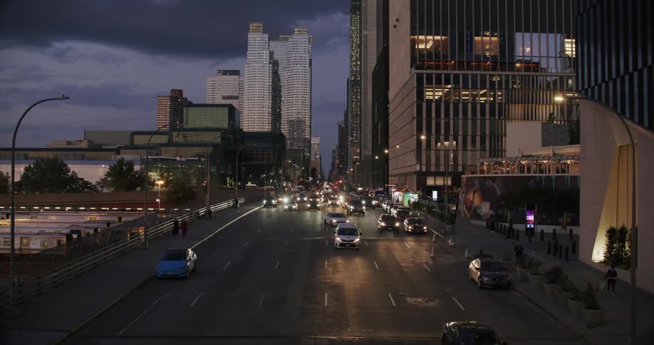 A busy avenue in the city center at dusk