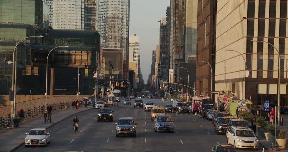Cars driving on a large avenue in the city at morning