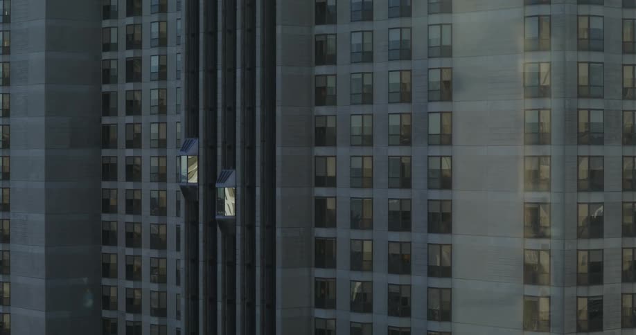 Elevators of a building moving up and down during the day