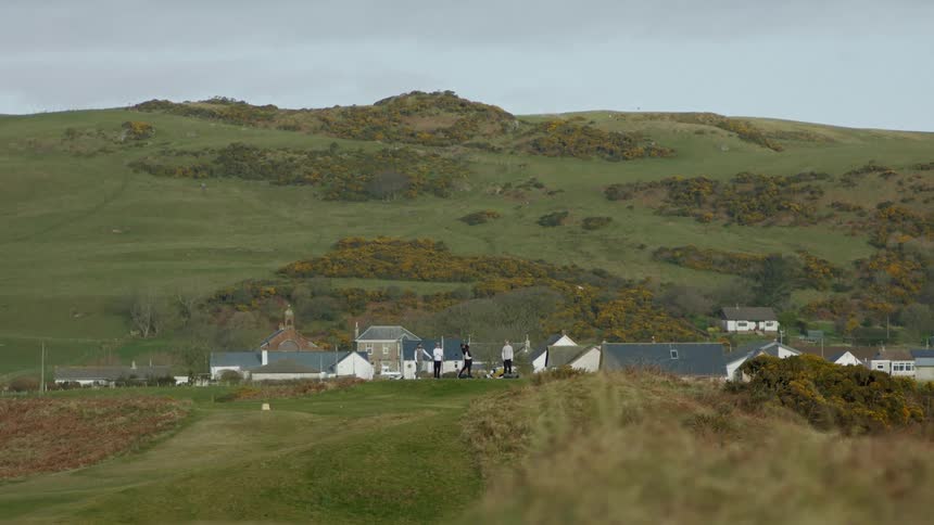 People playing golf in the countryside